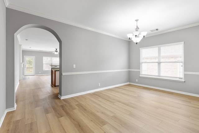 spare room featuring ornamental molding, ceiling fan with notable chandelier, and light wood-type flooring