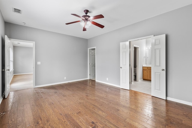 unfurnished bedroom with ceiling fan, light hardwood / wood-style floors, and ensuite bath