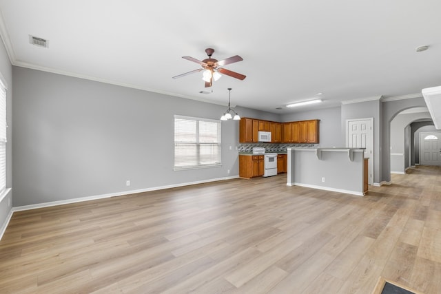 unfurnished living room with ceiling fan with notable chandelier, light hardwood / wood-style flooring, and crown molding