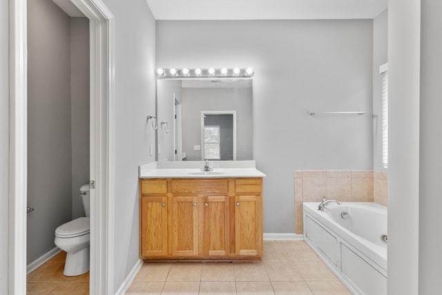 bathroom with toilet, vanity, tile patterned floors, and a bathing tub