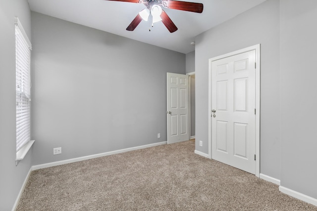 unfurnished bedroom featuring ceiling fan and light colored carpet