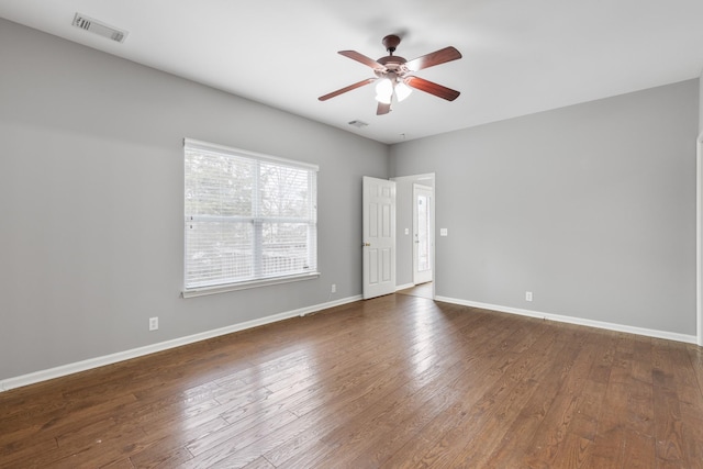 unfurnished room with ceiling fan and dark hardwood / wood-style flooring