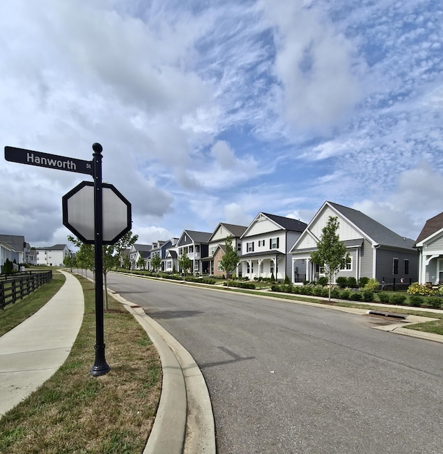 view of street featuring a residential view, curbs, and sidewalks