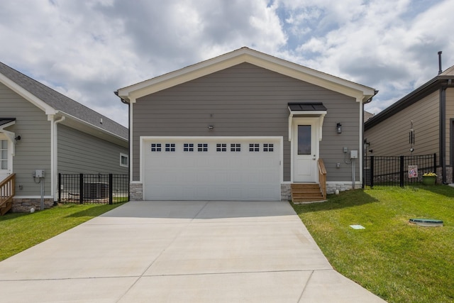 view of front of house with a garage and a front lawn