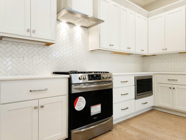 kitchen with built in microwave, stainless steel range, wall chimney range hood, light hardwood / wood-style flooring, and white cabinets