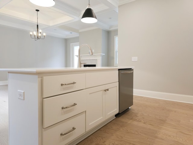 kitchen with white cabinets, light wood-type flooring, hanging light fixtures, and ornamental molding