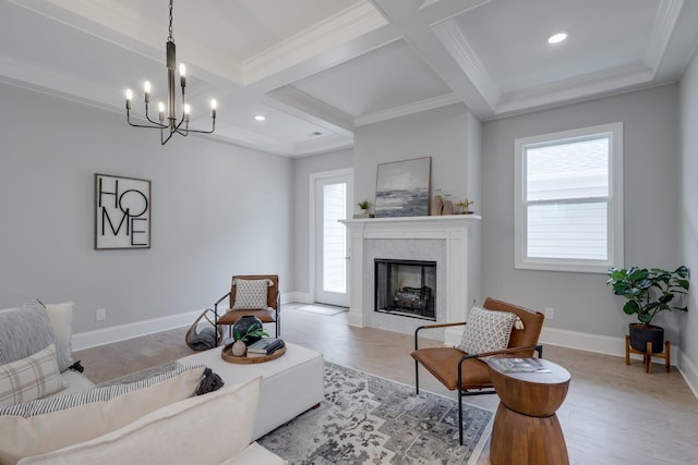 living room featuring beamed ceiling, ornamental molding, coffered ceiling, and a notable chandelier