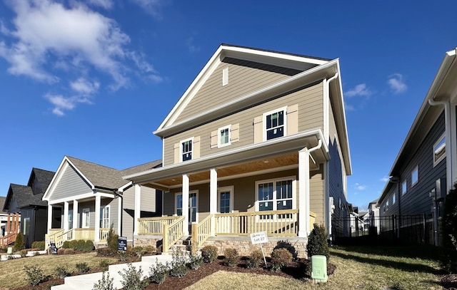 view of front of home with covered porch and fence