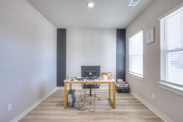 office featuring a healthy amount of sunlight and light hardwood / wood-style flooring