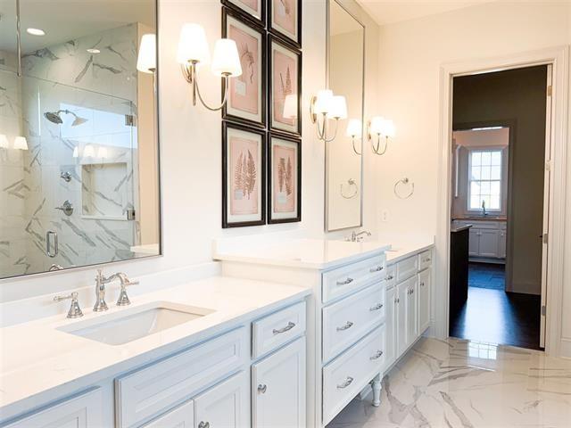 bathroom featuring walk in shower and vanity