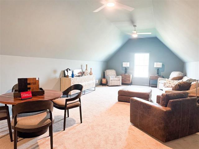 interior space with vaulted ceiling and ceiling fan