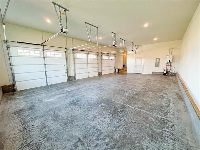 garage with a garage door opener and electric panel