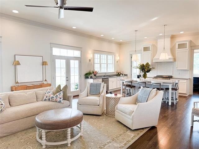 living room with sink, crown molding, ceiling fan, dark hardwood / wood-style floors, and french doors