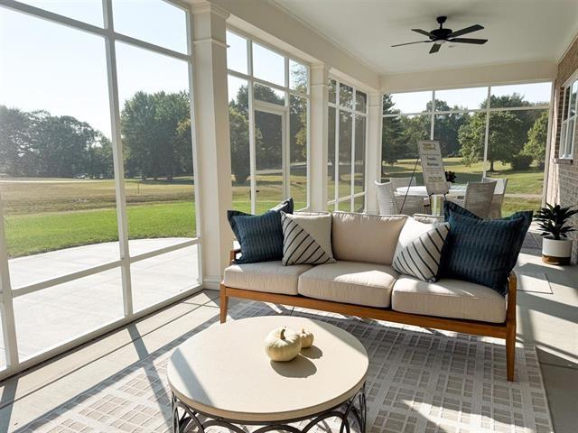 sunroom featuring ceiling fan