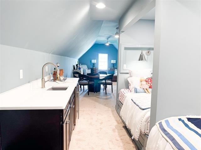 interior space with vaulted ceiling, sink, and ceiling fan