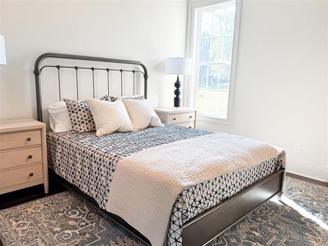 bedroom with dark hardwood / wood-style flooring