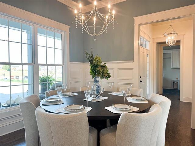 dining area featuring dark hardwood / wood-style flooring and a chandelier