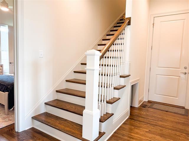 staircase with hardwood / wood-style flooring