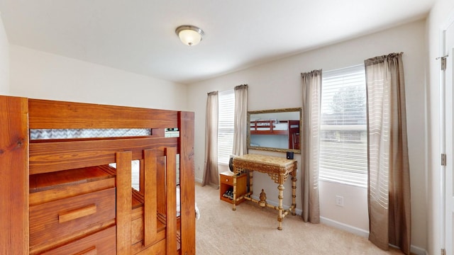 carpeted bedroom featuring multiple windows