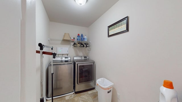 clothes washing area with washing machine and clothes dryer