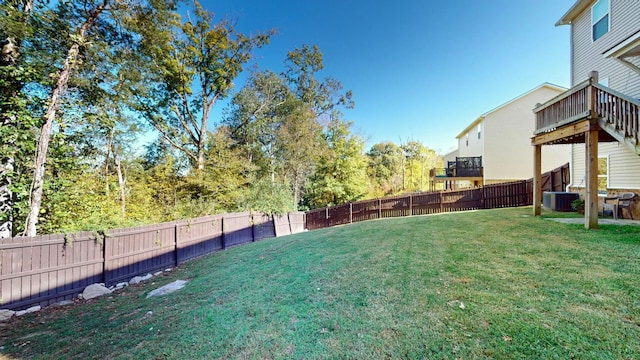 view of yard with central AC unit and a wooden deck