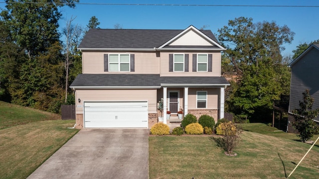 view of front of home featuring a front yard and a garage