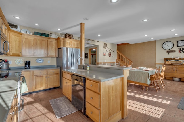 kitchen with light brown cabinets, an island with sink, stainless steel appliances, and sink