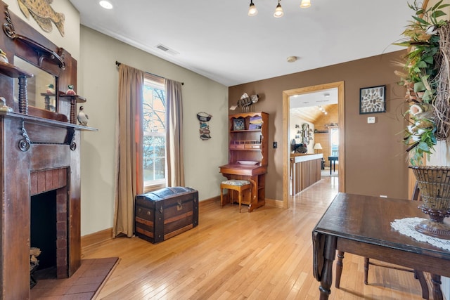 interior space featuring a fireplace and light hardwood / wood-style flooring