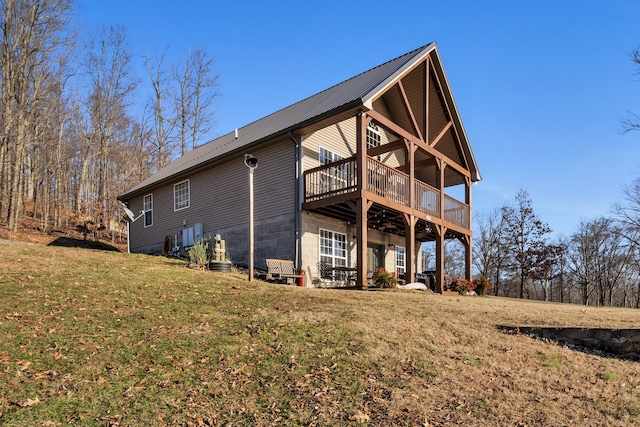 rear view of property with a yard and a wooden deck