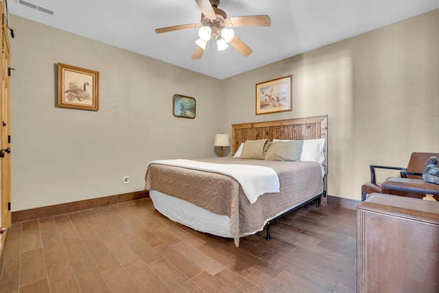 bedroom with ceiling fan and wood-type flooring