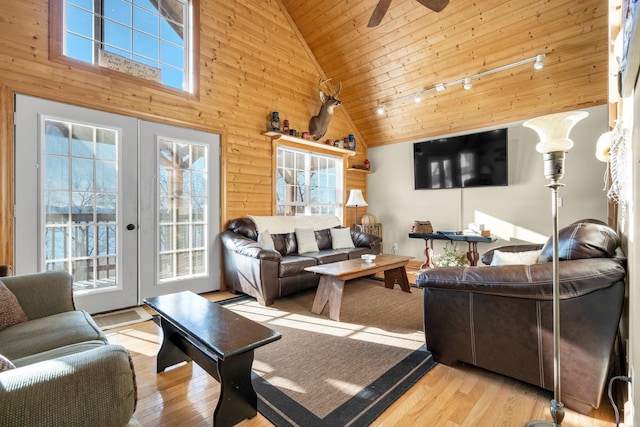 living room featuring ceiling fan, light hardwood / wood-style flooring, high vaulted ceiling, and wood ceiling