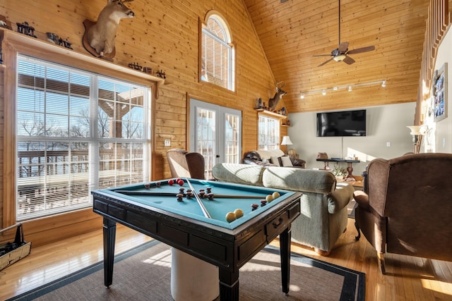 rec room featuring high vaulted ceiling, french doors, billiards, ceiling fan, and light wood-type flooring