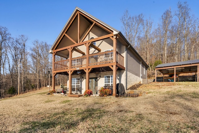 rear view of property with a lawn and a deck