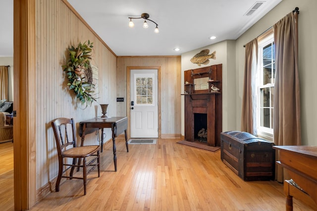 foyer entrance featuring wood walls and light wood-type flooring