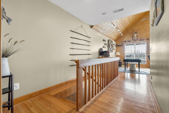 hallway featuring wood-type flooring, wooden ceiling, and high vaulted ceiling