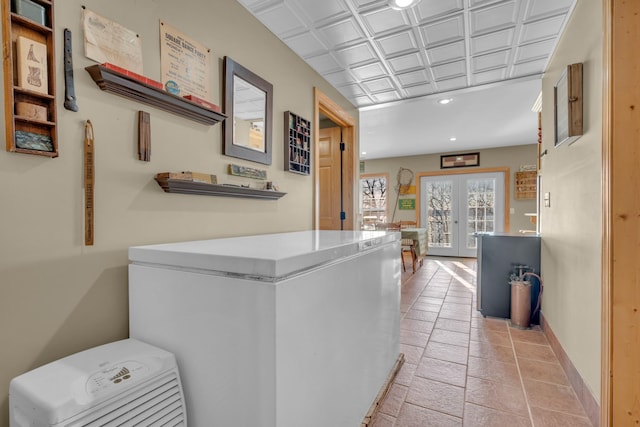 kitchen featuring french doors, refrigerator, and light tile patterned flooring