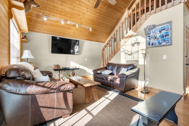 living room with rail lighting, vaulted ceiling, ceiling fan, light wood-type flooring, and wood ceiling