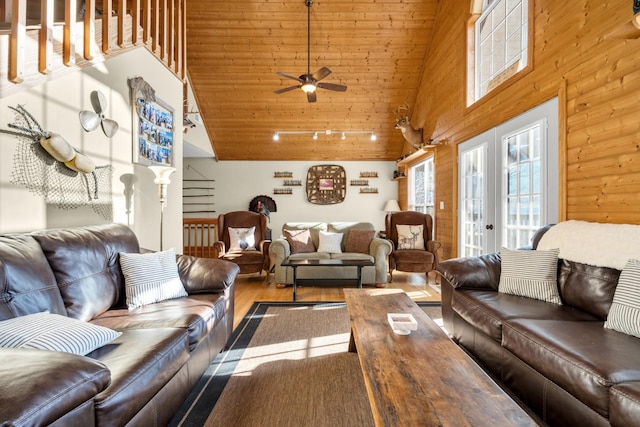 living room with french doors, wood-type flooring, high vaulted ceiling, wooden ceiling, and wood walls