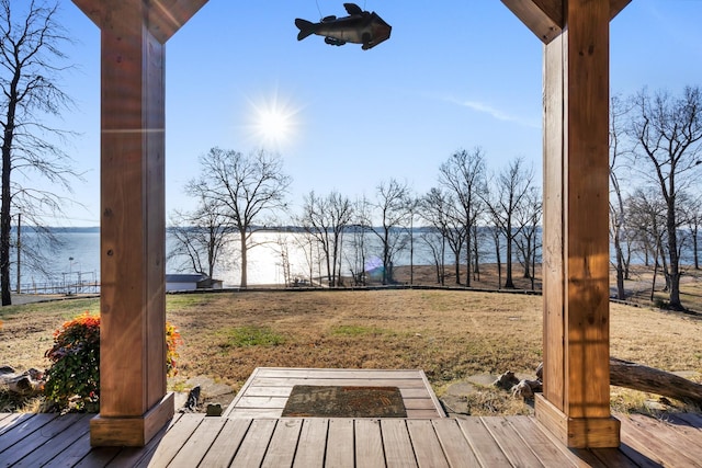 deck featuring a lawn and a water view