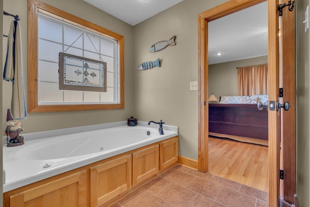 bathroom with a bathtub and tile patterned flooring