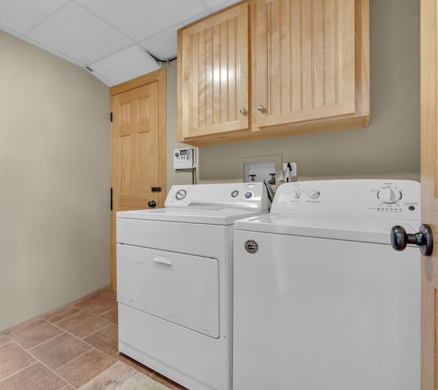 laundry area featuring cabinet space, independent washer and dryer, and light tile patterned floors