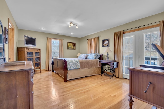 bedroom with light wood-style floors and access to exterior