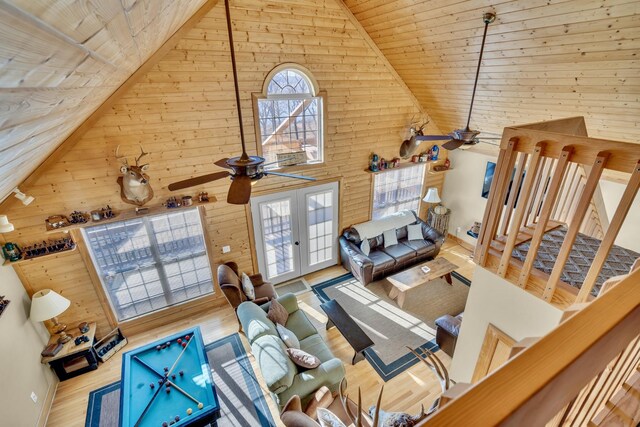 unfurnished living room featuring wooden ceiling, ceiling fan, high vaulted ceiling, and wood finished floors