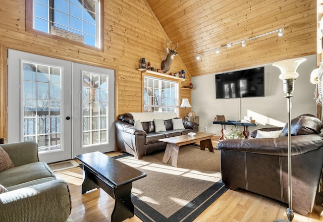 living room with a wealth of natural light, french doors, wood finished floors, and wood ceiling