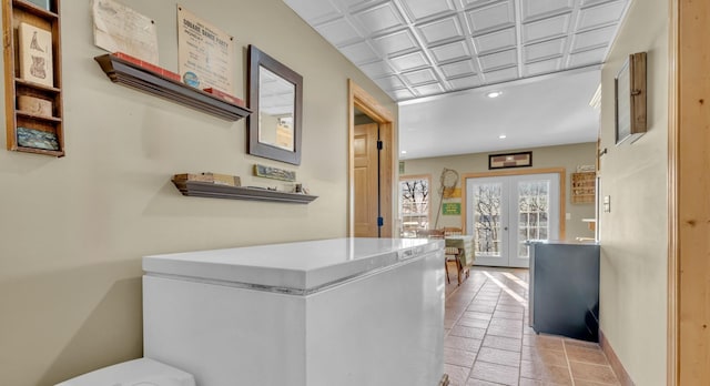 hallway with baseboards, french doors, an ornate ceiling, and recessed lighting