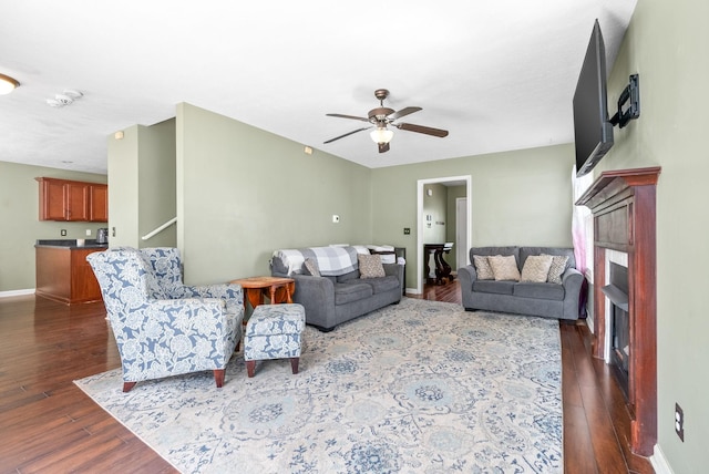 living room with ceiling fan and dark hardwood / wood-style floors