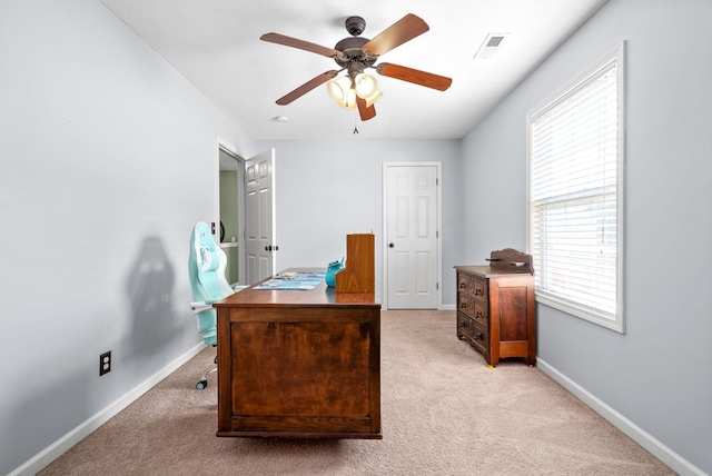 office featuring ceiling fan, light carpet, and a wealth of natural light