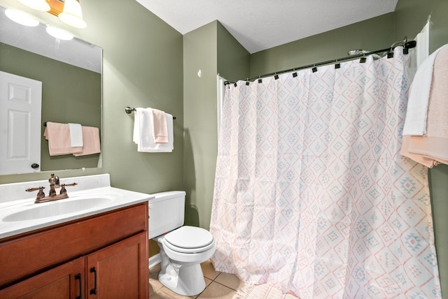 bathroom featuring tile patterned flooring, vanity, and toilet