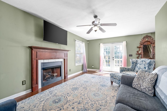 living room featuring ceiling fan, french doors, and wood-type flooring