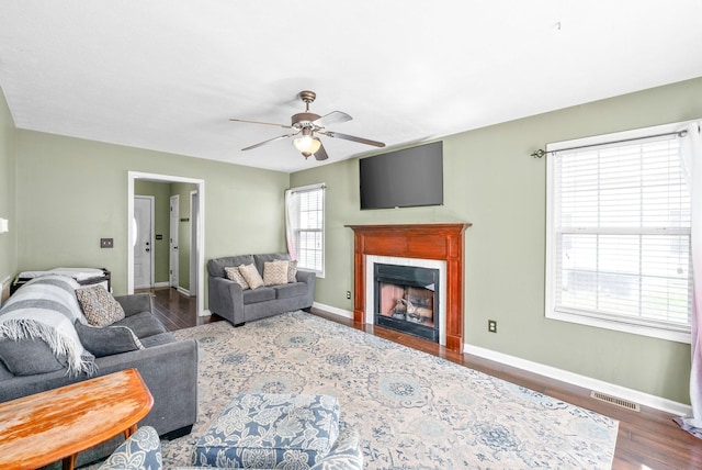 living room with dark hardwood / wood-style floors and ceiling fan